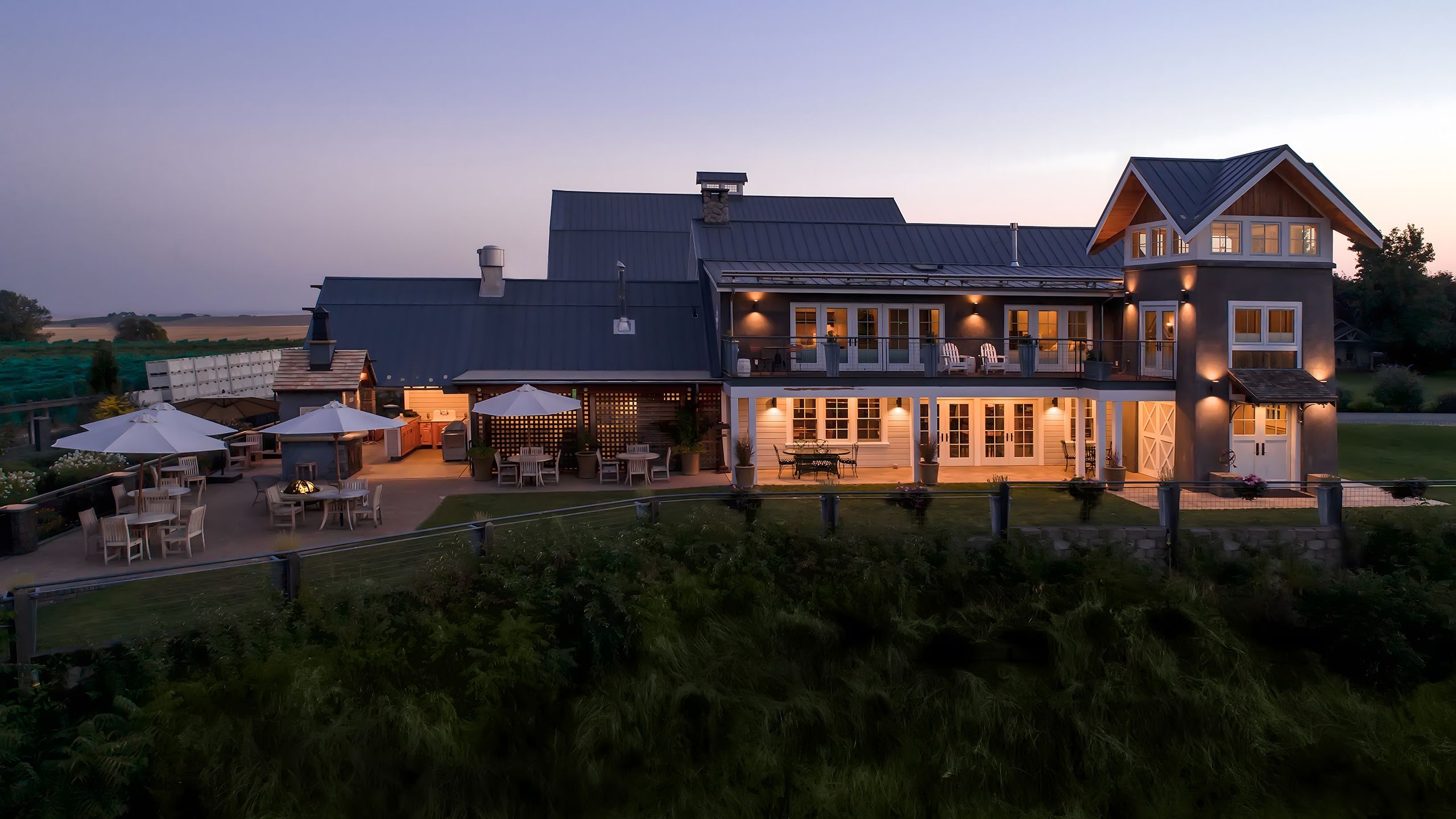 The Abeja estate illuminated at night against a dark sky